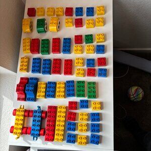 Duplos, with two rolling blocks, and two face blocks with movable googly eyes